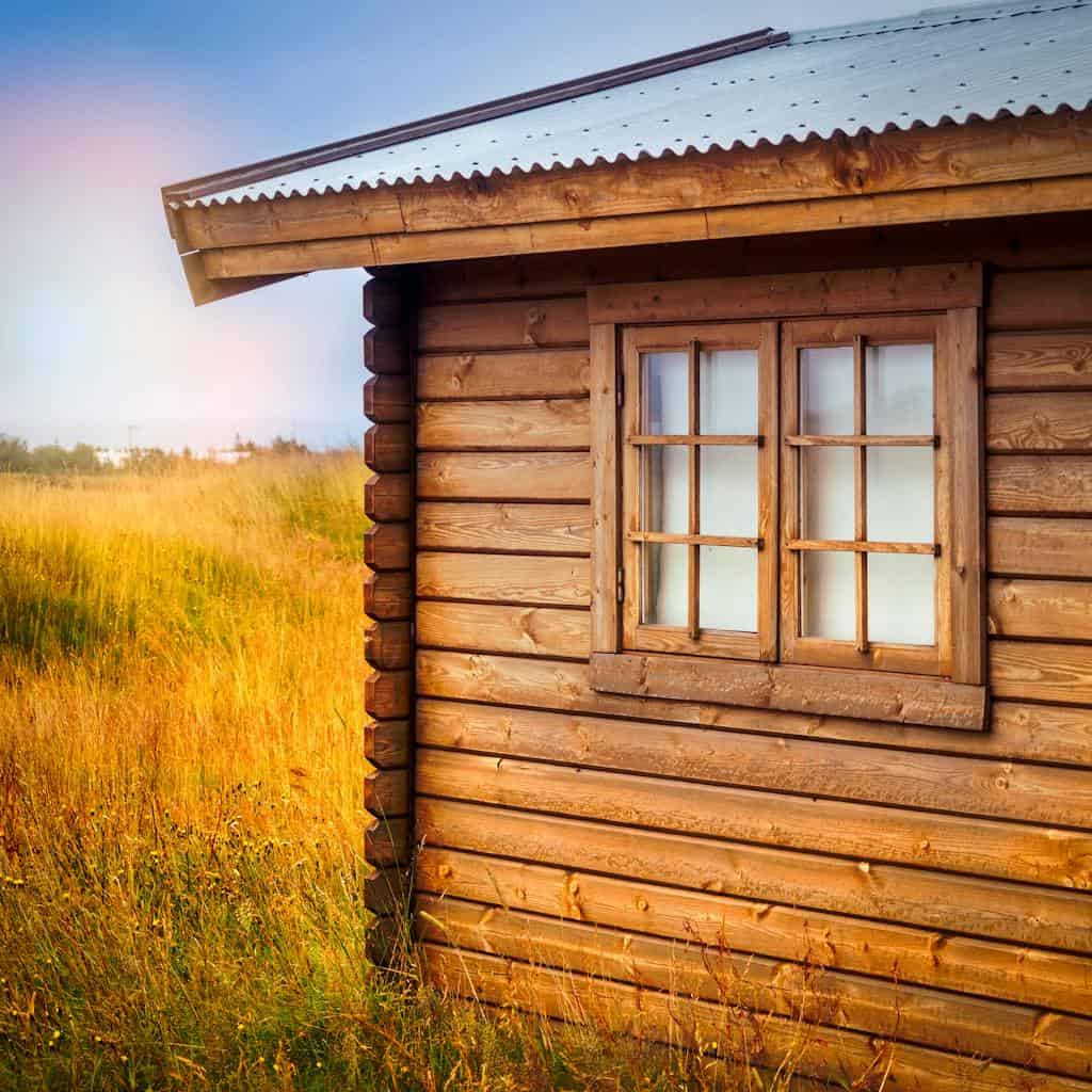 Brown Wooden Cottage at the Field during Day how to find land to buy for a homestead